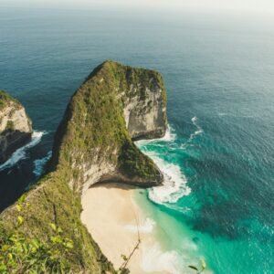 aerial photo of green dense island in teal calm body of water at daytime